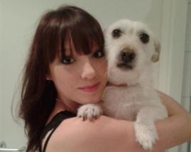 Michelle Sippel holding a white dog.