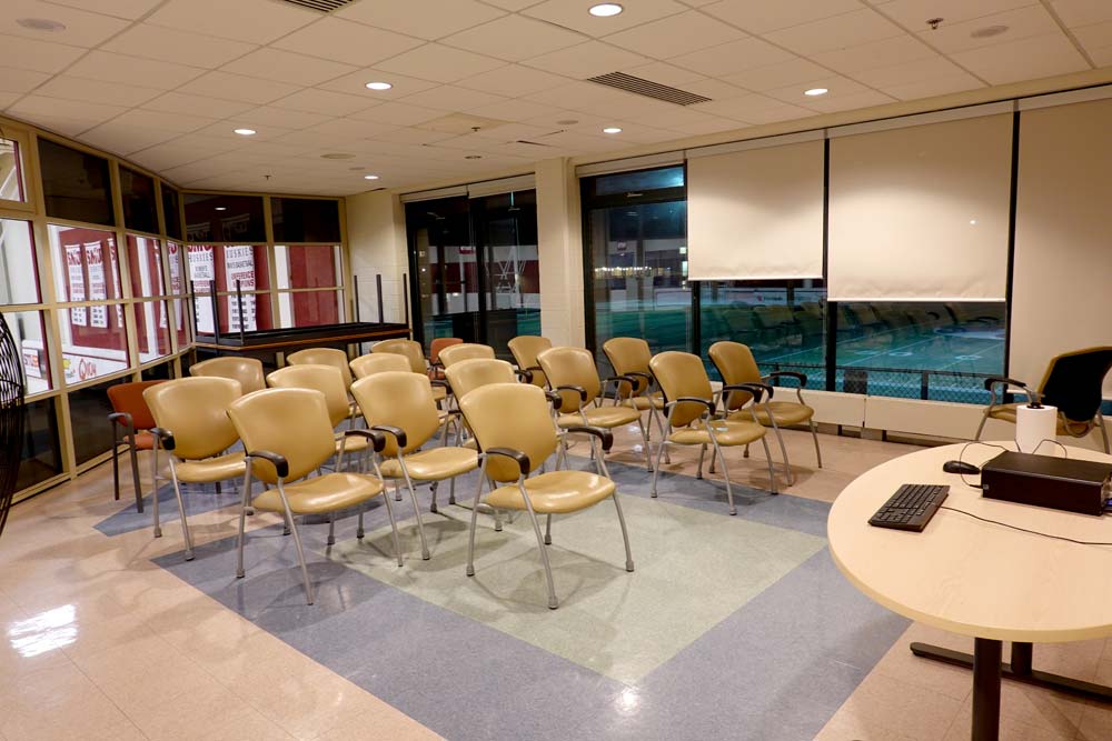 VIP Lounge with chairs in several rows facing the front of the room.