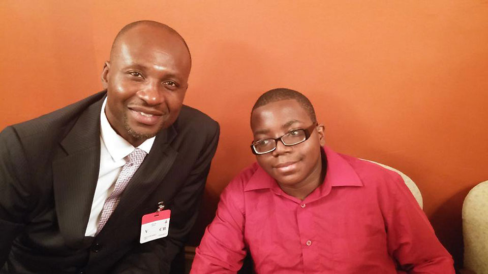 Will Njoku sitting with a young man.